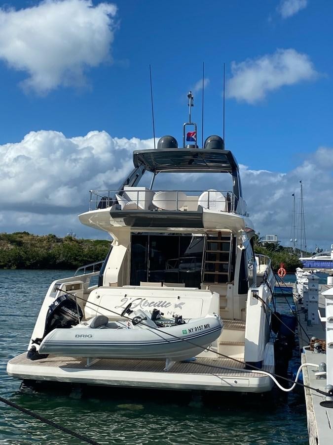 a boat docked at a pier aboard L’ABEILLE Yacht for Sale