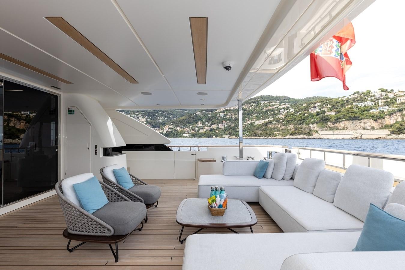 a living room with a large window overlooking a body of water aboard EROS Yacht for Sale