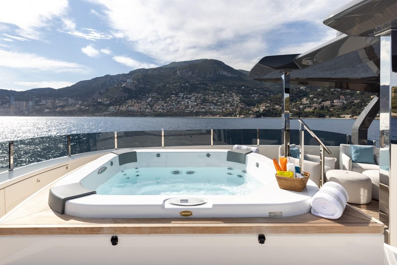 a large white pool on a deck overlooking a city aboard EROS Yacht for Sale