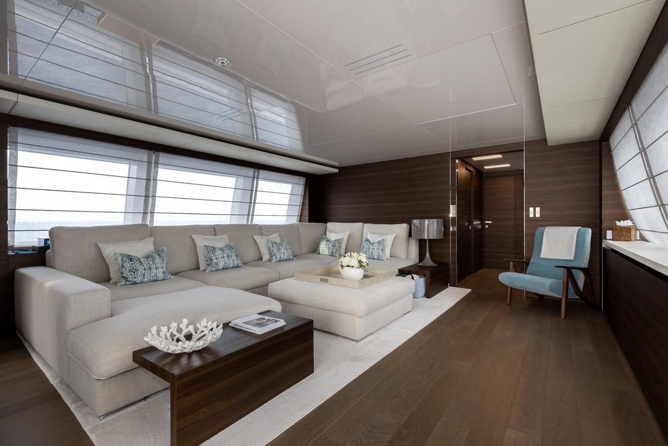 a living room with a couch and a table aboard EROS Yacht for Sale