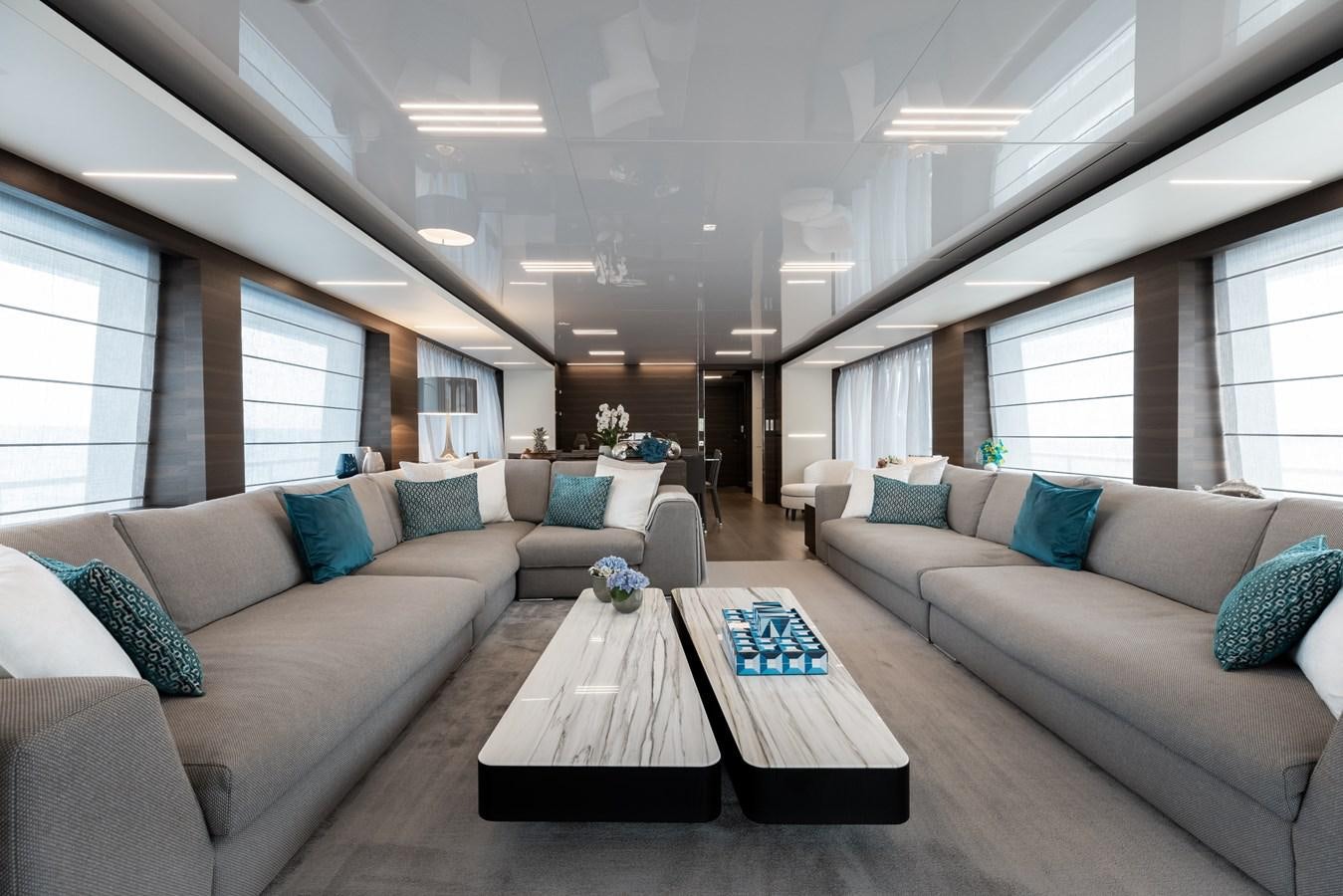 a living room with a couch and a coffee table aboard EROS Yacht for Sale
