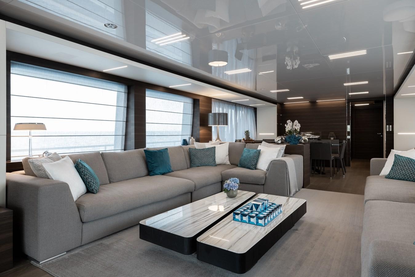 a living room with a couch and a coffee table aboard EROS Yacht for Sale