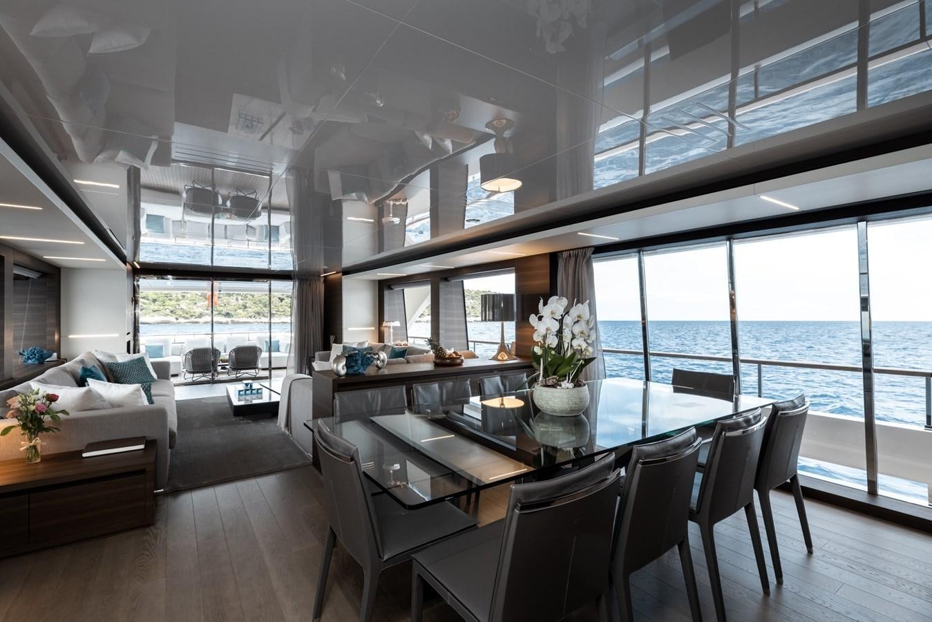 a large room with a table and chairs aboard EROS Yacht for Sale