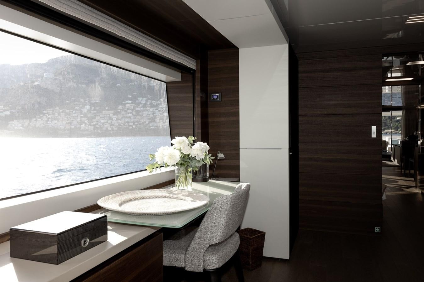 a table with a plate and a vase of flowers on it aboard EROS Yacht for Sale