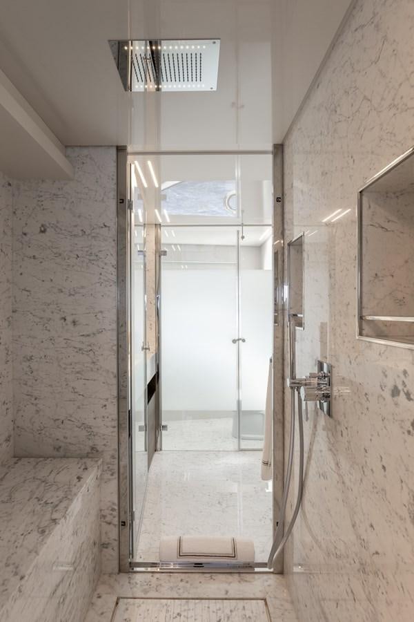 a hallway with a glass door aboard EROS Yacht for Sale