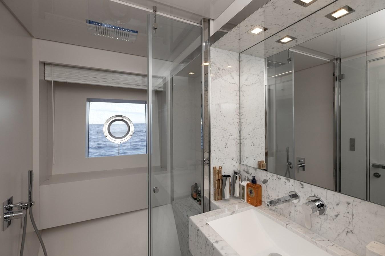 a bathroom with a glass shower aboard EROS Yacht for Sale