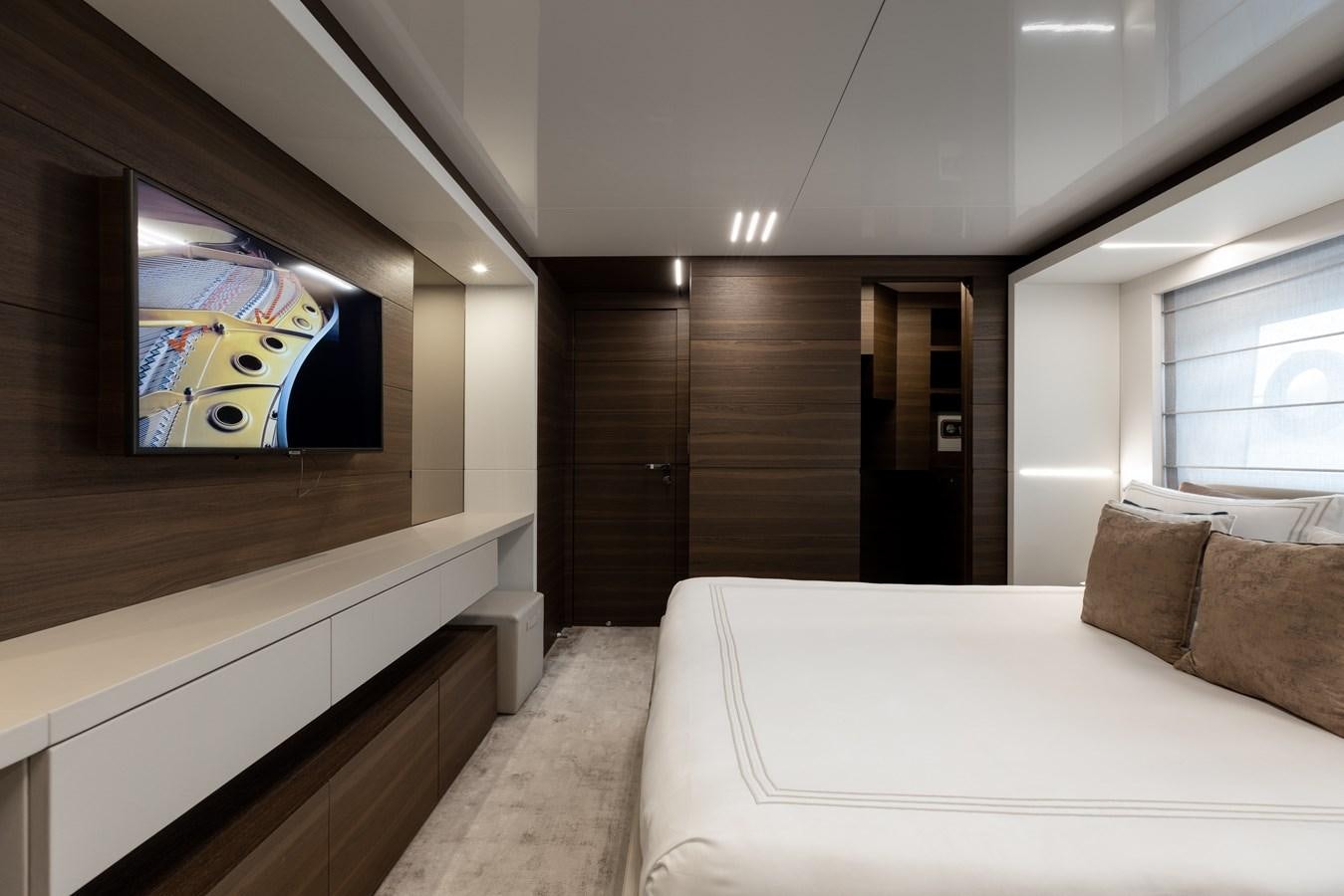a room with a bed and a tv on the wall aboard EROS Yacht for Sale