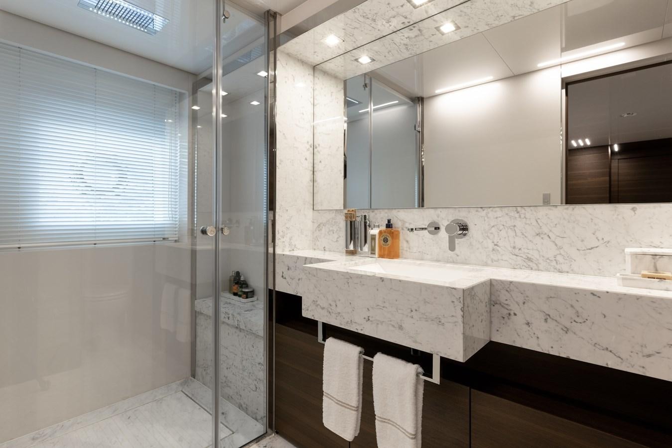 a bathroom with a large mirror aboard EROS Yacht for Sale