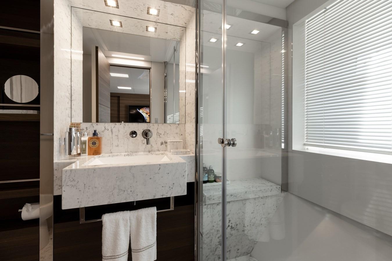 a bathroom with a glass shower aboard EROS Yacht for Sale