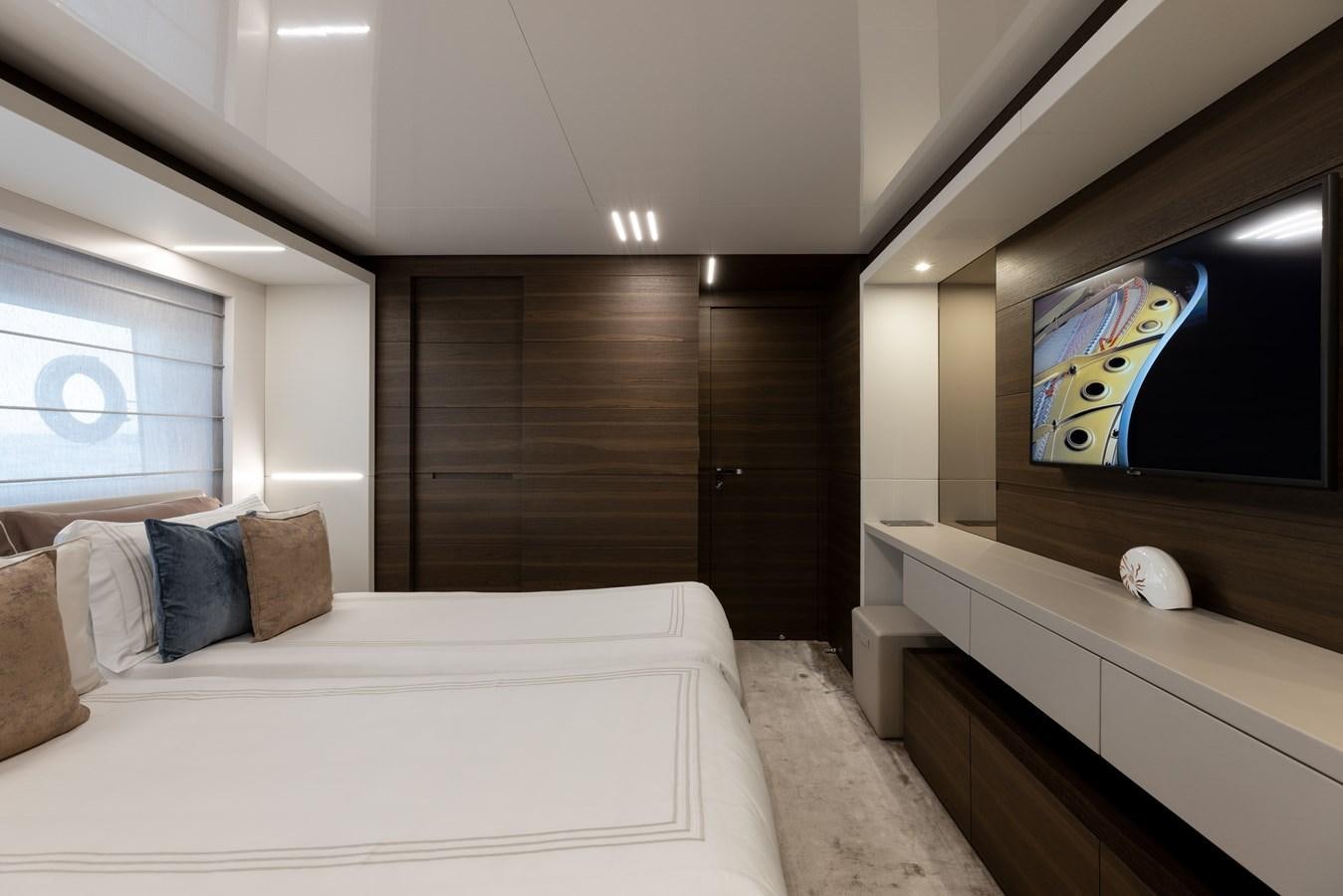 a room with a bed and a tv aboard EROS Yacht for Sale