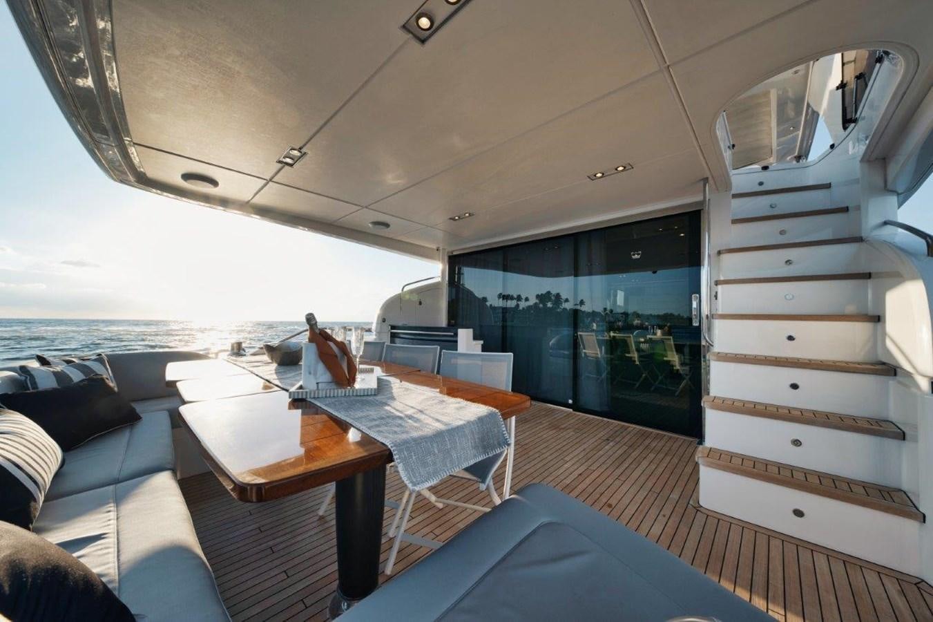 a boat with a table and chairs aboard PRONTO Yacht for Sale
