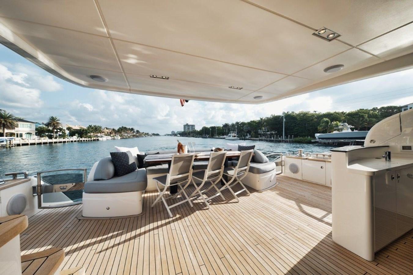 a boat dock with lounge chairs and a large body of water aboard PRONTO Yacht for Sale