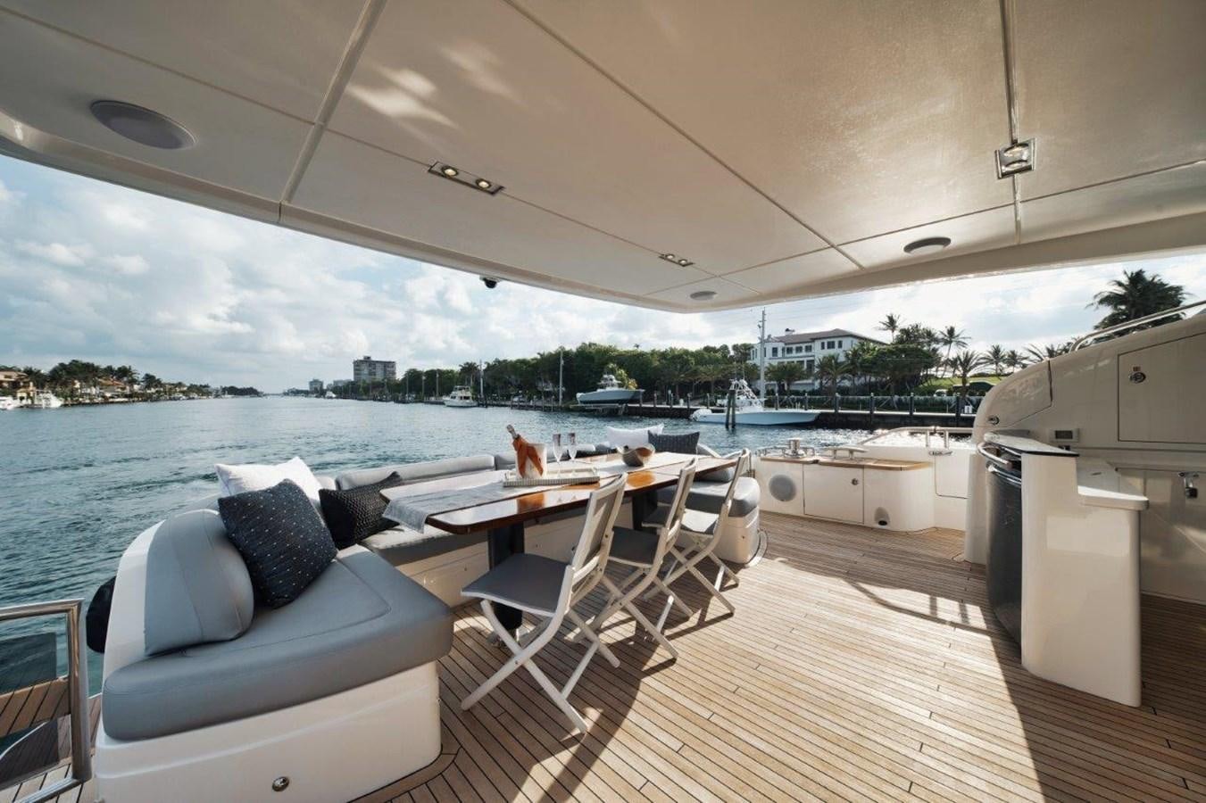 a large room with a couch and a table and chairs aboard PRONTO Yacht for Sale