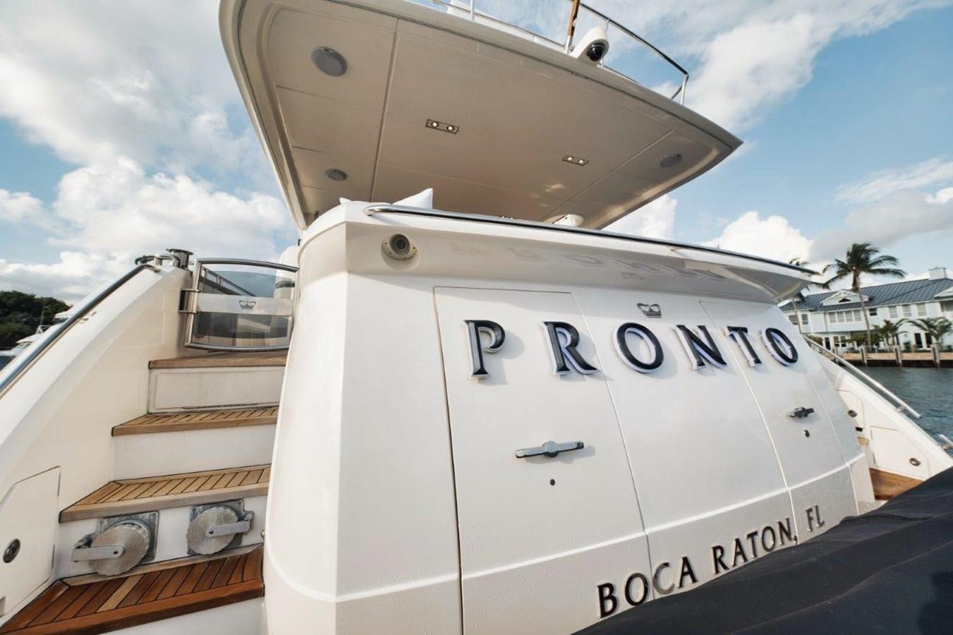 a white boat with a black and white logo on the front aboard PRONTO Yacht for Sale