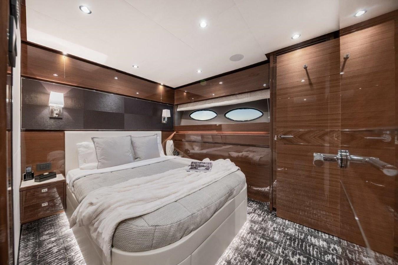 a room with a bed and a wood cabinet aboard PRONTO Yacht for Sale