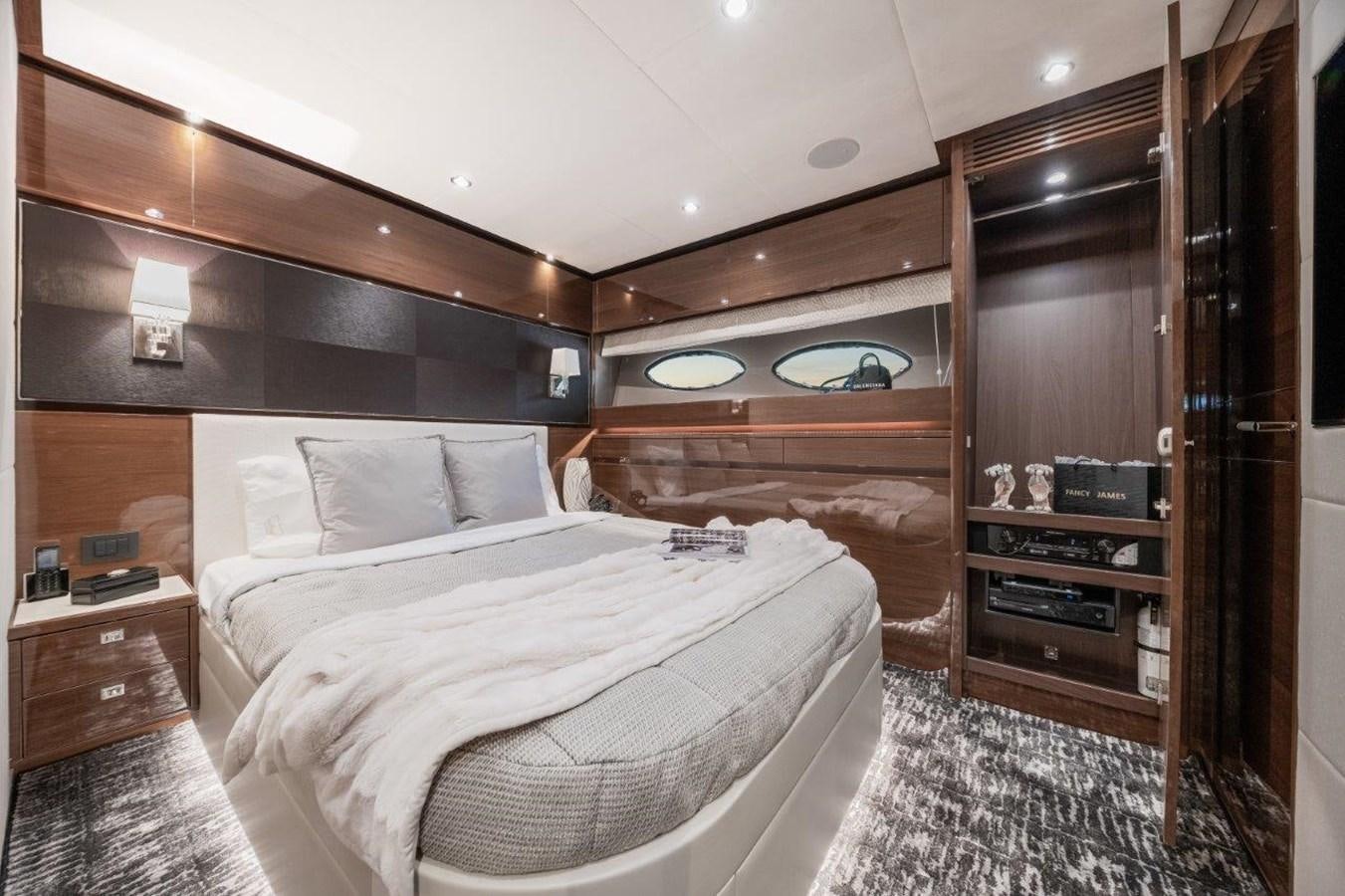 a bedroom with a bed and a dresser aboard PRONTO Yacht for Sale