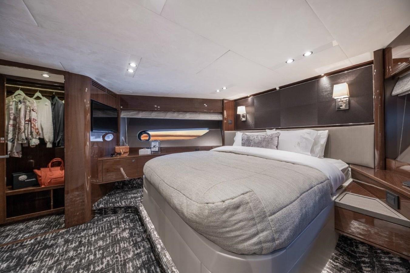 a bedroom with a bed and a mirror aboard PRONTO Yacht for Sale