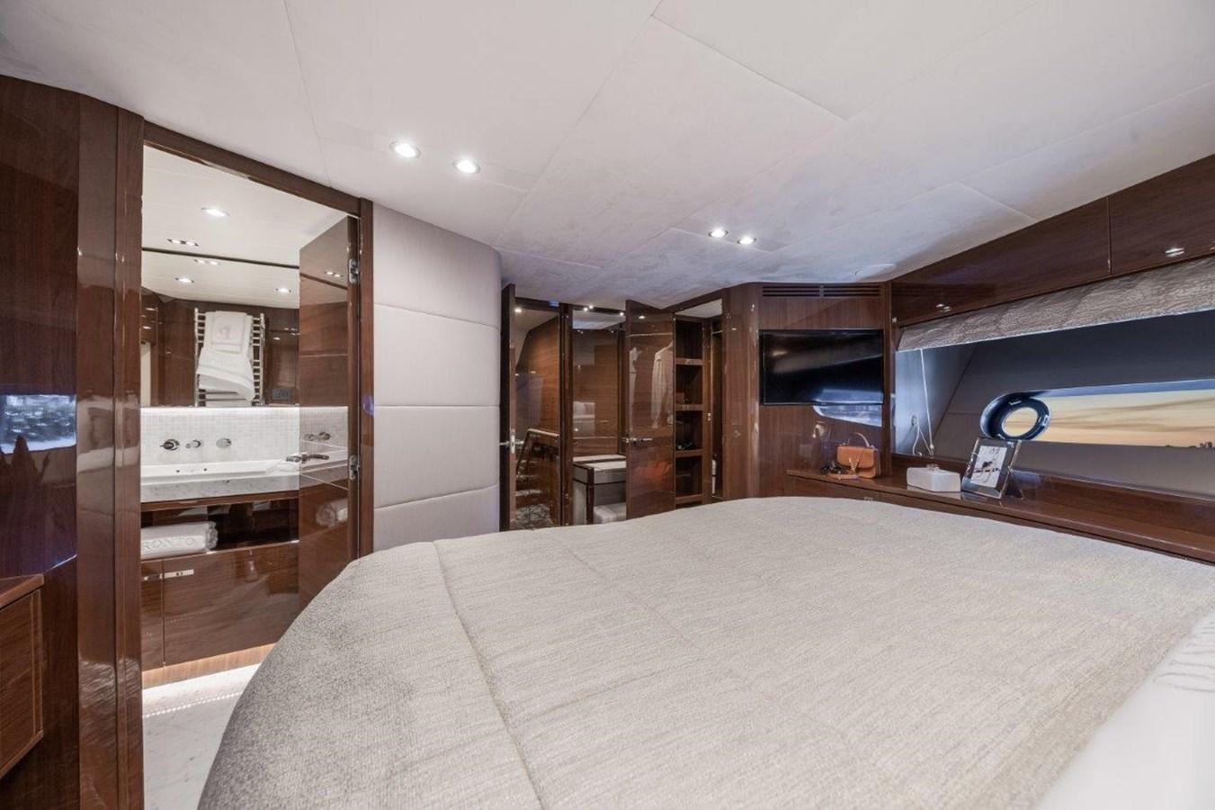 a bedroom with a bed and a mirror aboard PRONTO Yacht for Sale