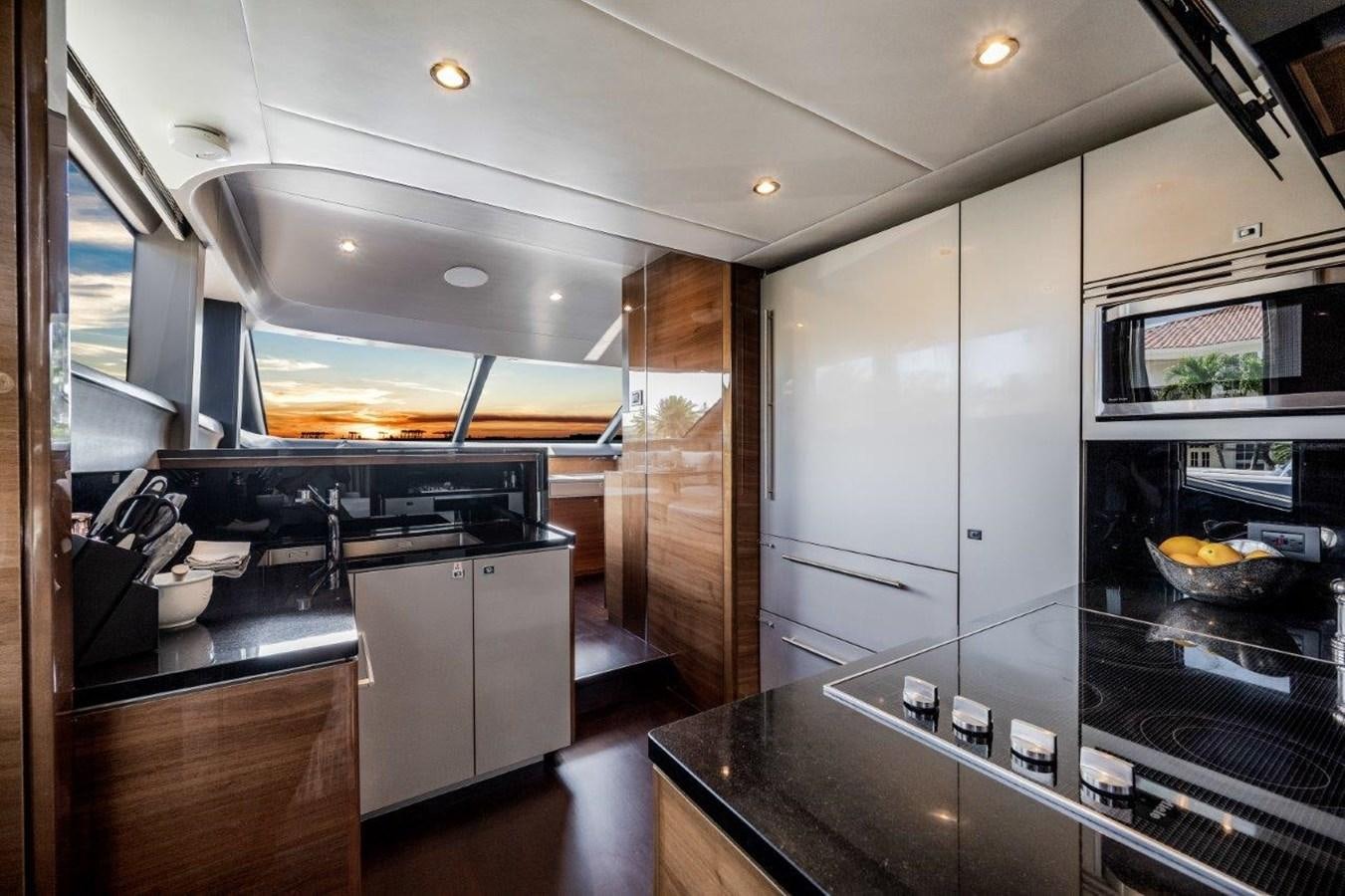 a kitchen with a large glass display aboard PRONTO Yacht for Sale