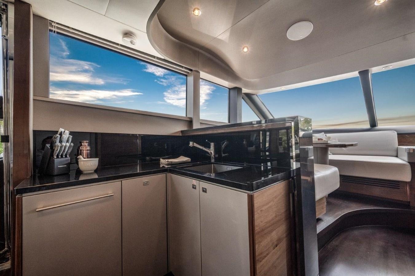 a kitchen with a large window aboard PRONTO Yacht for Sale