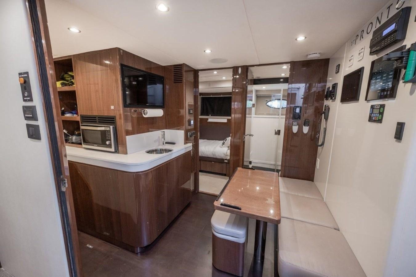 a kitchen with a table and microwave aboard PRONTO Yacht for Sale