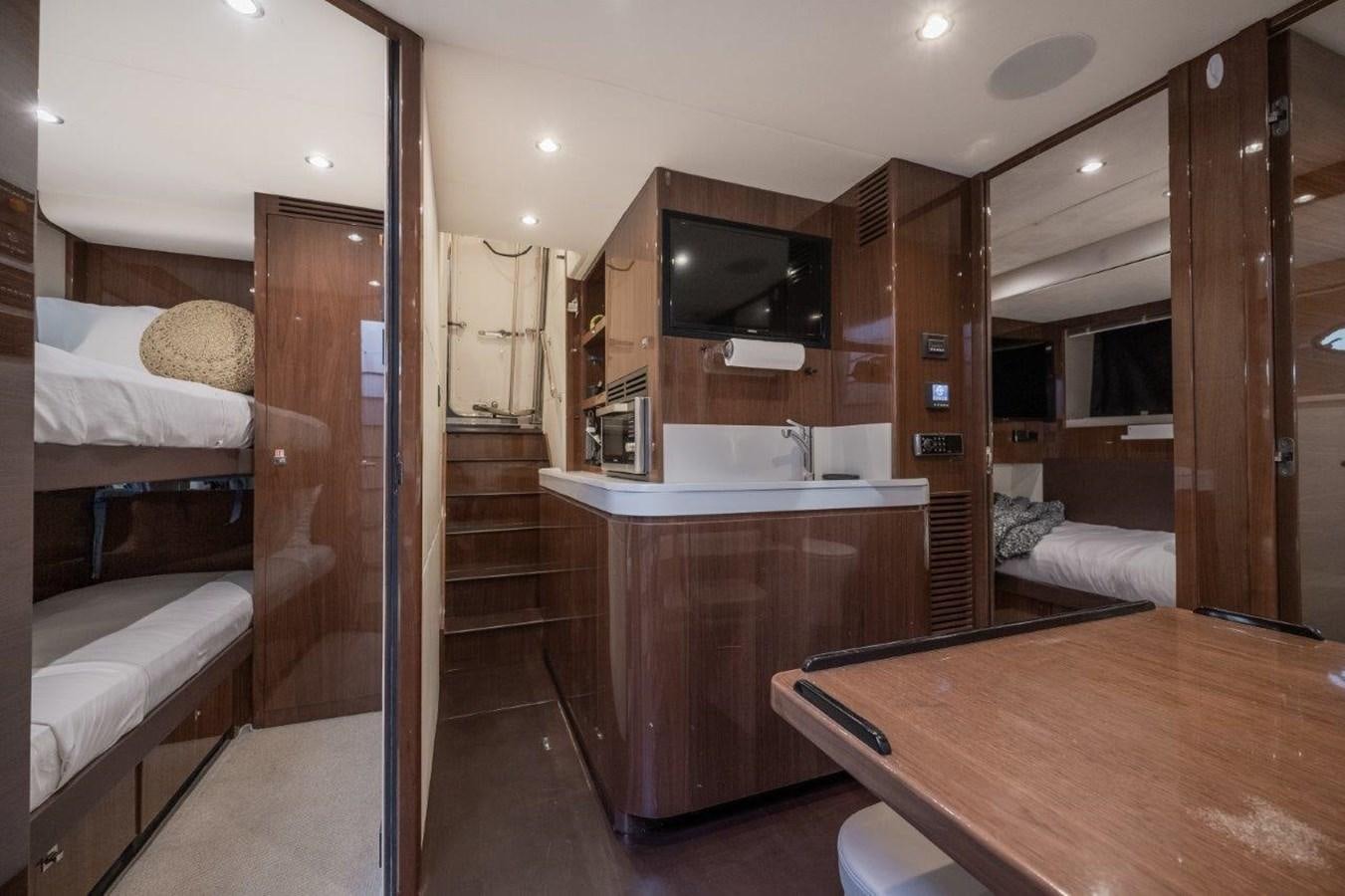a bathroom with a sink and a bed aboard PRONTO Yacht for Sale