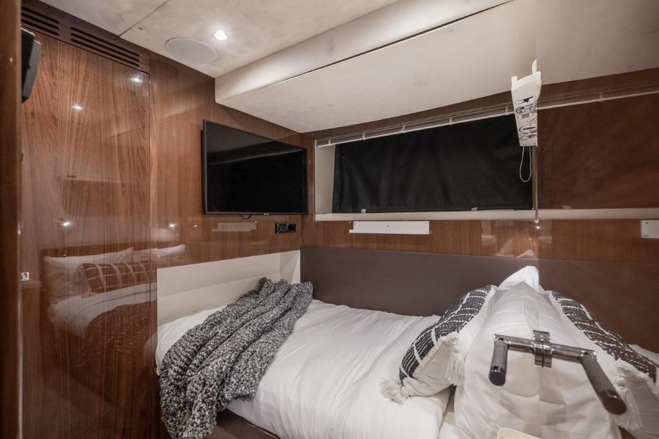 a room with a bed and a television aboard PRONTO Yacht for Sale