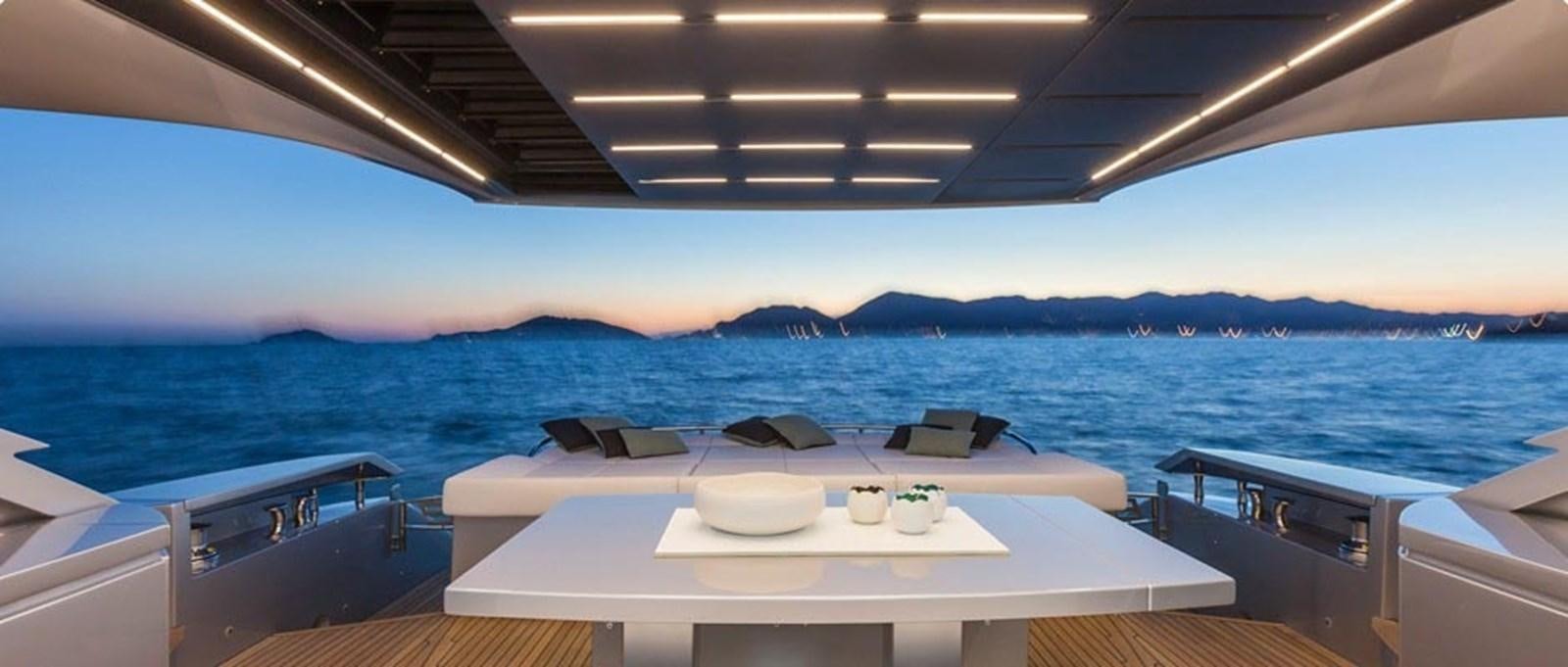 a room with a table and chairs on it and a body of water in the background aboard 2014 PERSHING 82 Yacht for Sale