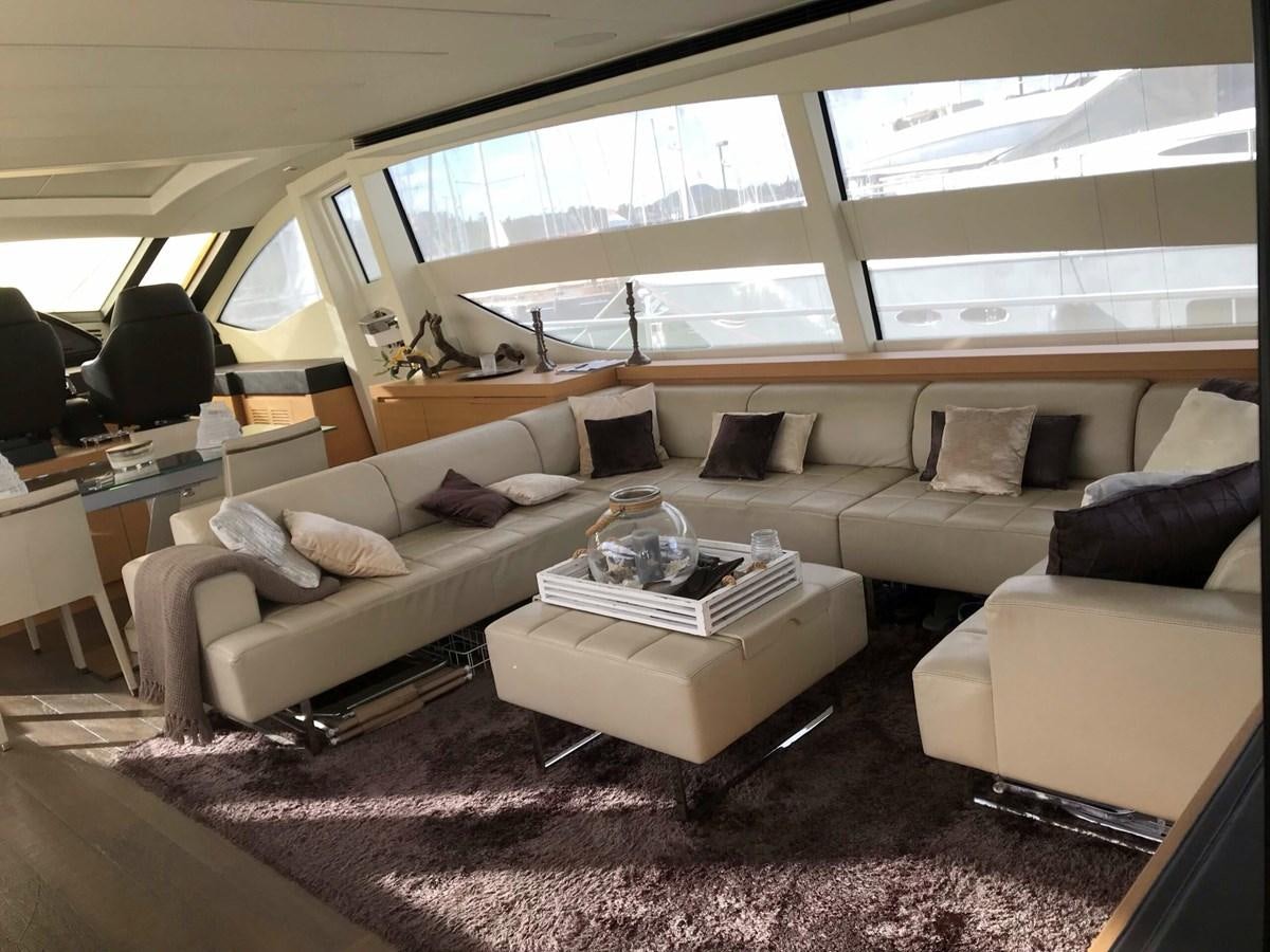 a living room with a couch and a coffee table aboard 2014 PERSHING 82 Yacht for Sale