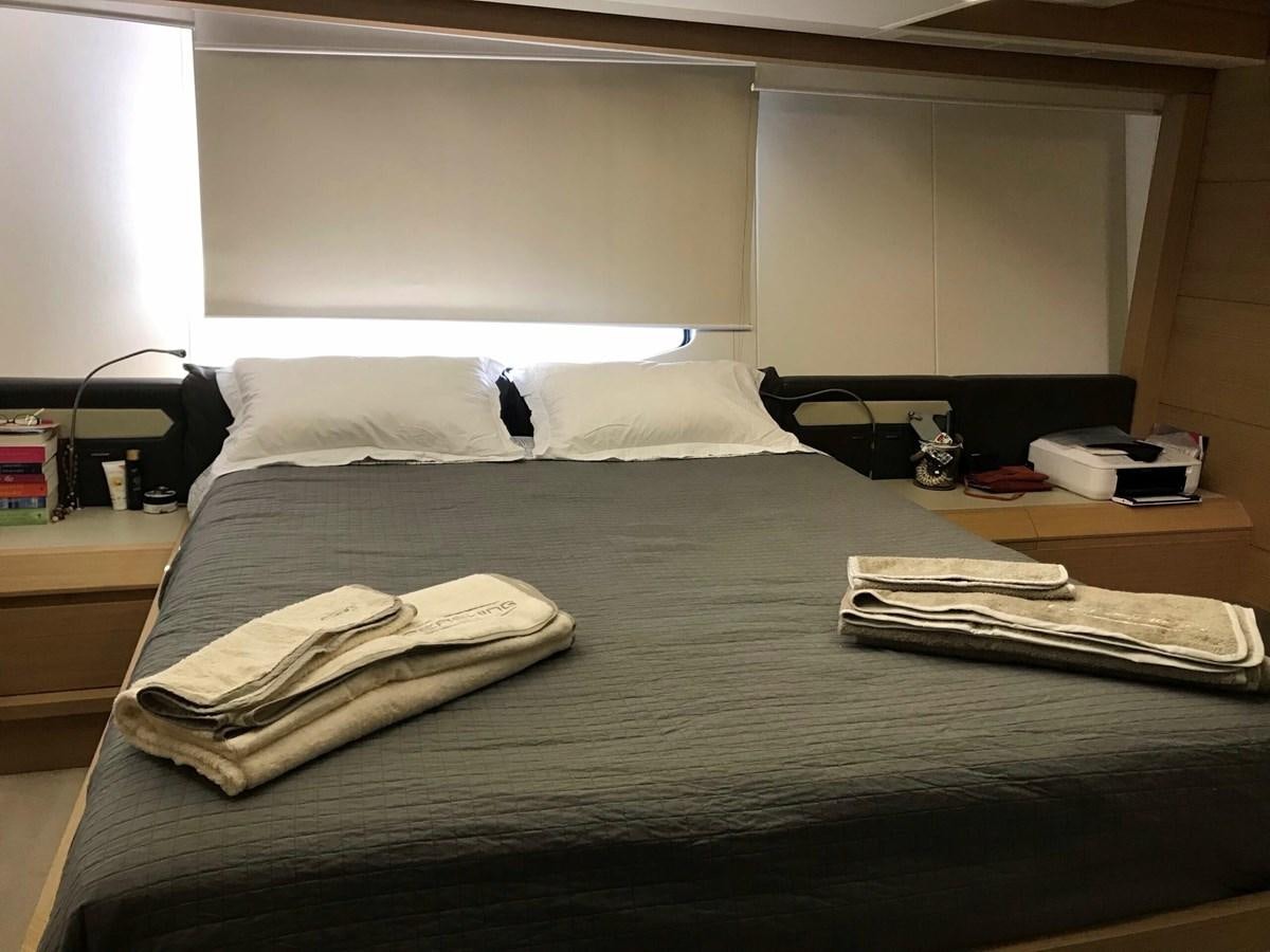 a bed with a black comforter aboard 2014 PERSHING 82 Yacht for Sale