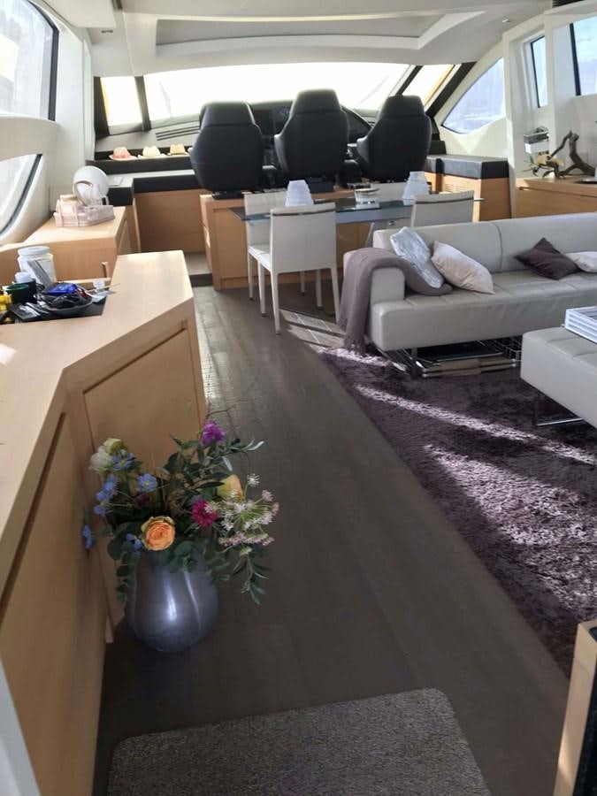 a living room with a couch and chairs aboard 2014 PERSHING 82 Yacht for Sale