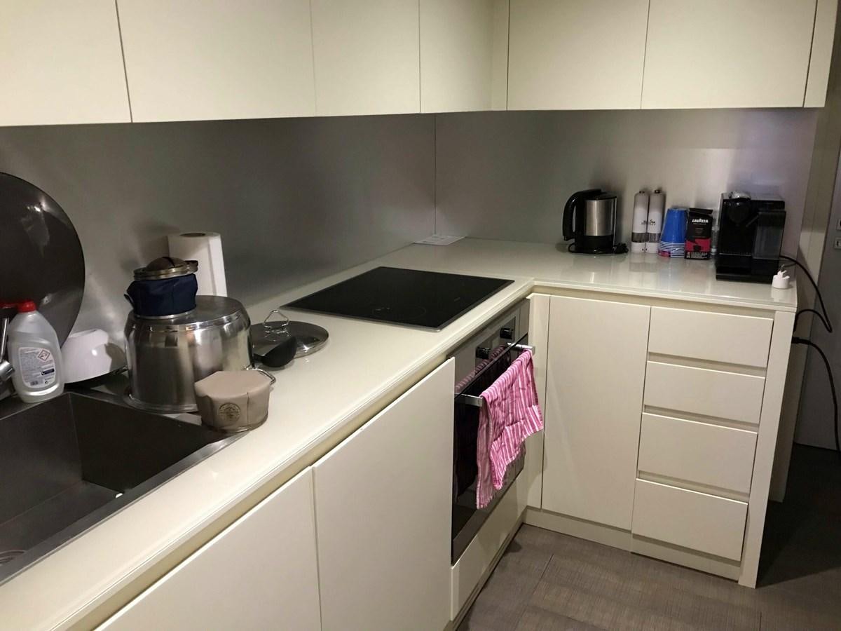 a kitchen with white cabinets aboard 2014 PERSHING 82 Yacht for Sale