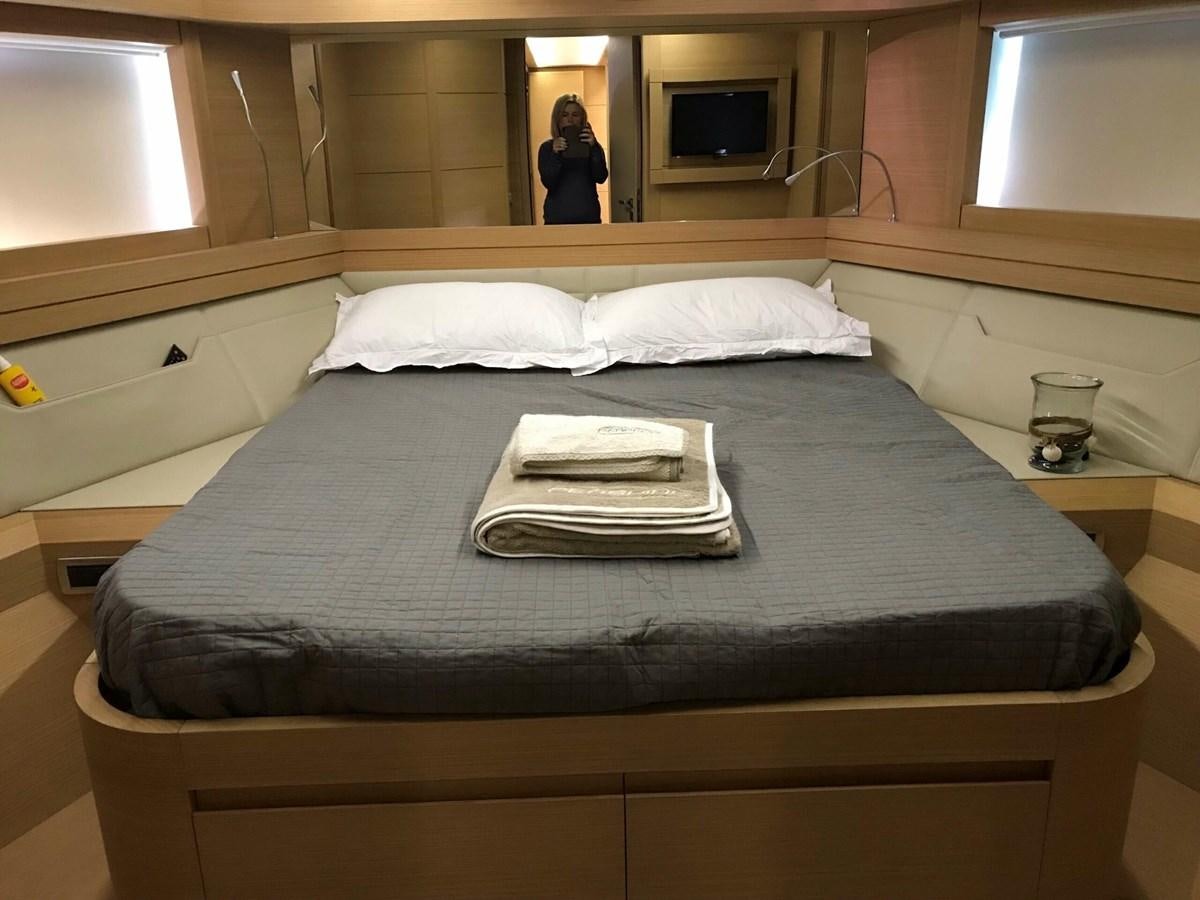 a bed with a towel on it aboard 2014 PERSHING 82 Yacht for Sale