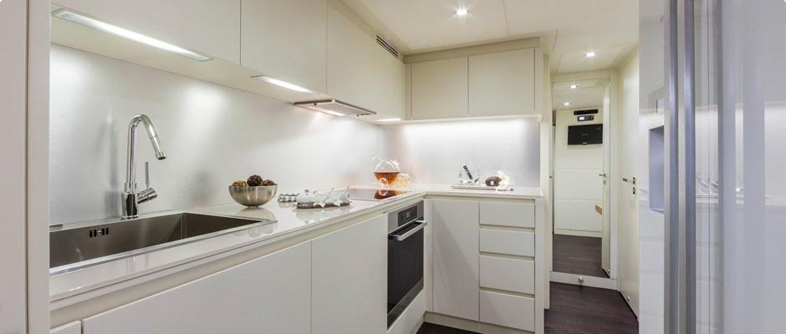 a kitchen with white cabinets aboard 2014 PERSHING 82 Yacht for Sale