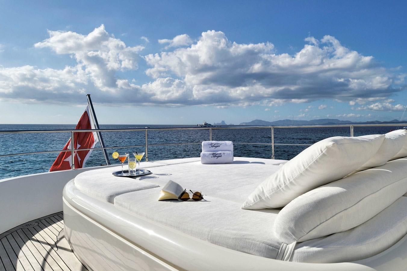 a boat with a red sail on the water aboard WHISPERING ANGEL Yacht for Sale