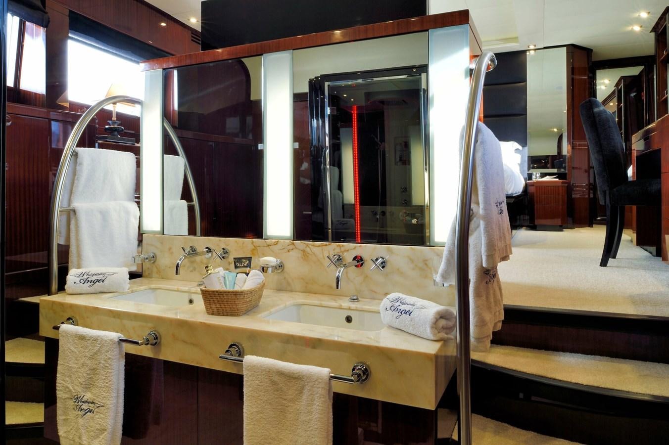 a bathroom with a large mirror aboard WHISPERING ANGEL Yacht for Sale