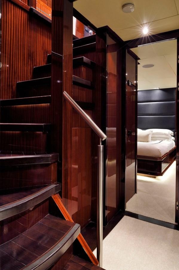 a room with a wood door and a bed aboard WHISPERING ANGEL Yacht for Sale