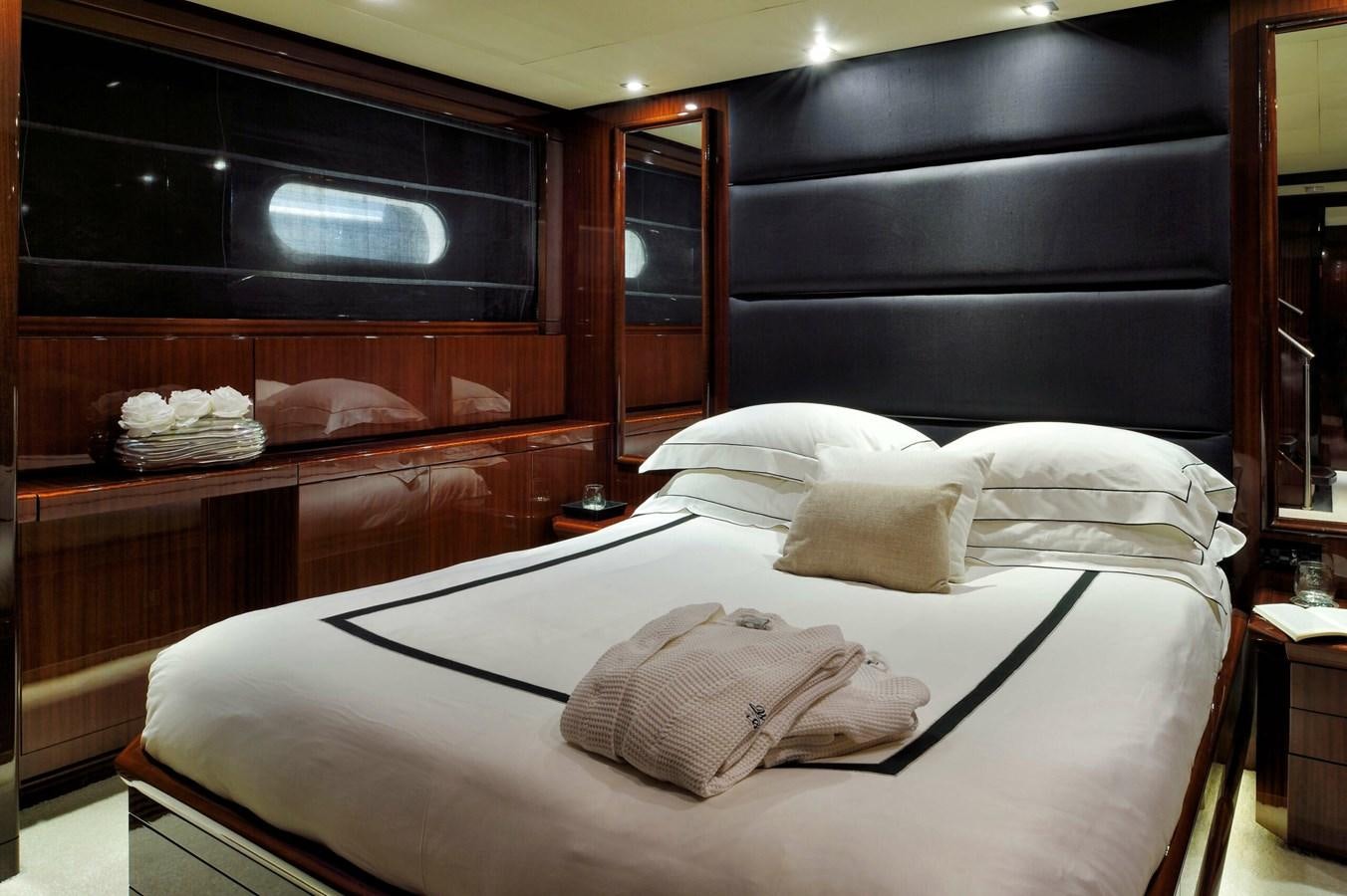 a bed with a white comforter aboard WHISPERING ANGEL Yacht for Sale