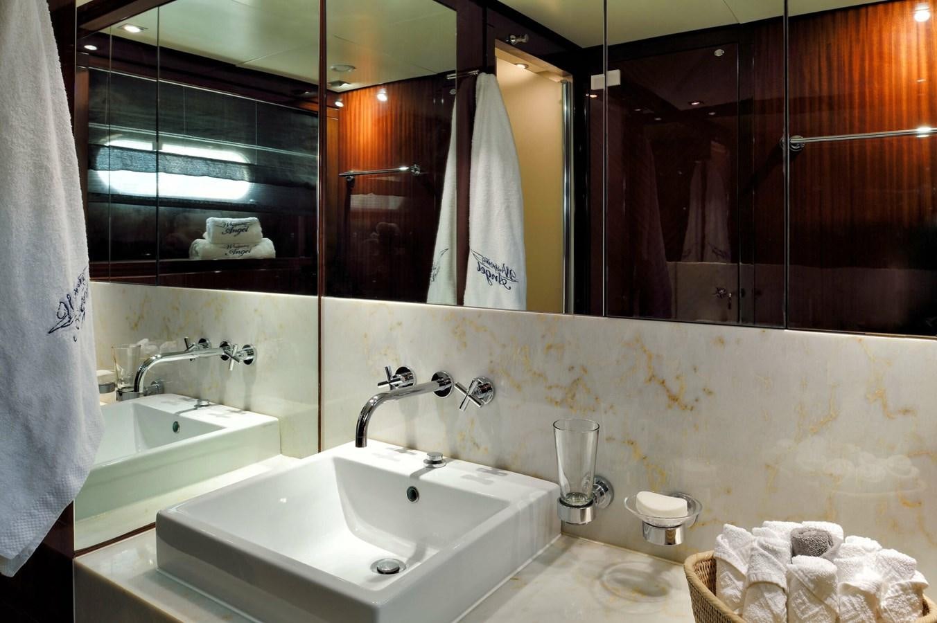 a bathroom with a large mirror aboard WHISPERING ANGEL Yacht for Sale