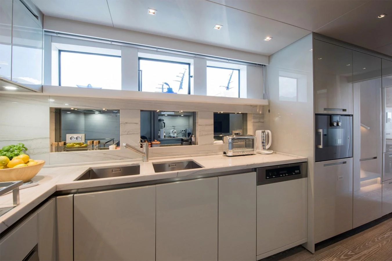a kitchen with white cabinets aboard 2016 SANLORENZO SL106 #625 Yacht for Sale