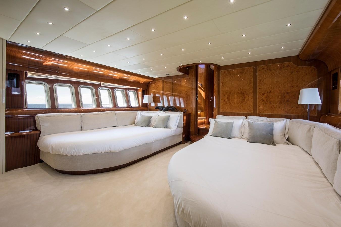 a room with a bed and a couch aboard CITA Yacht for Sale