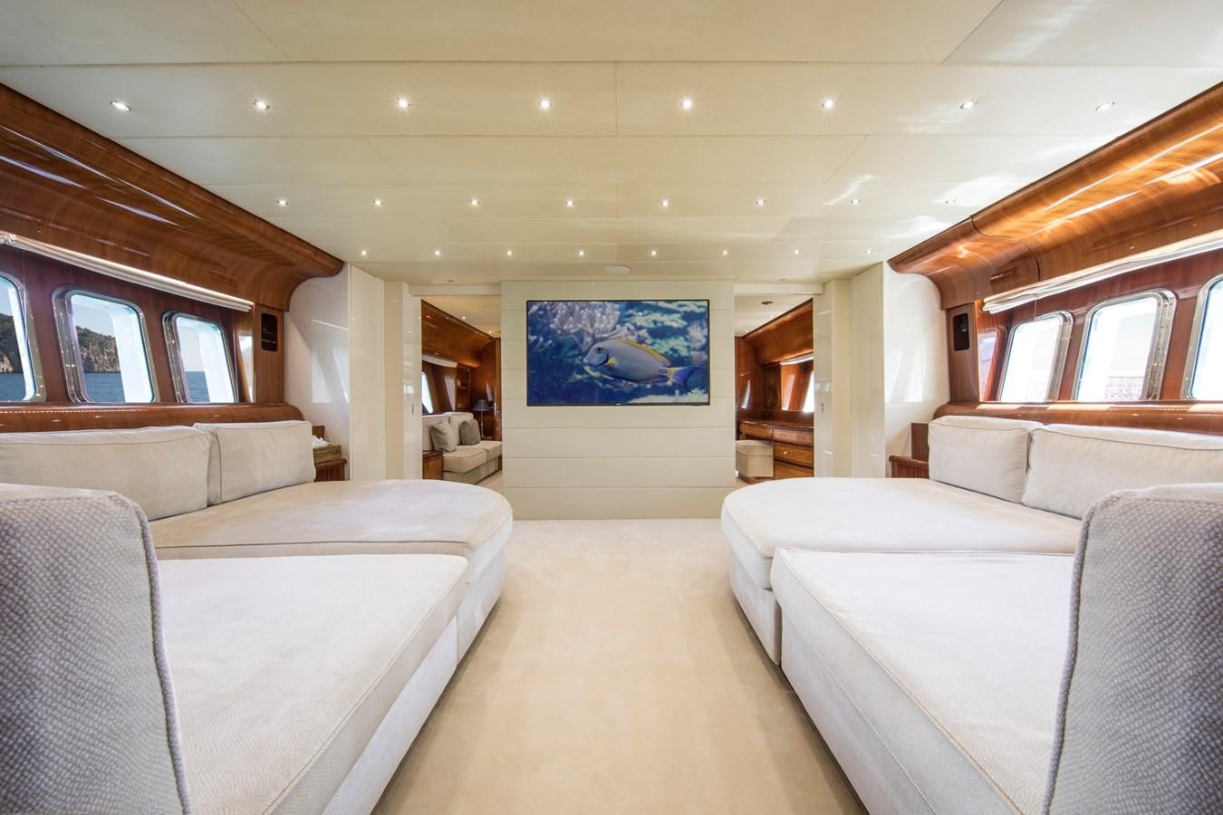 a room with couches and a television aboard CITA Yacht for Sale