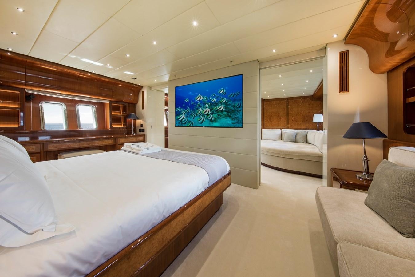 a room with a bed and a couch aboard CITA Yacht for Sale