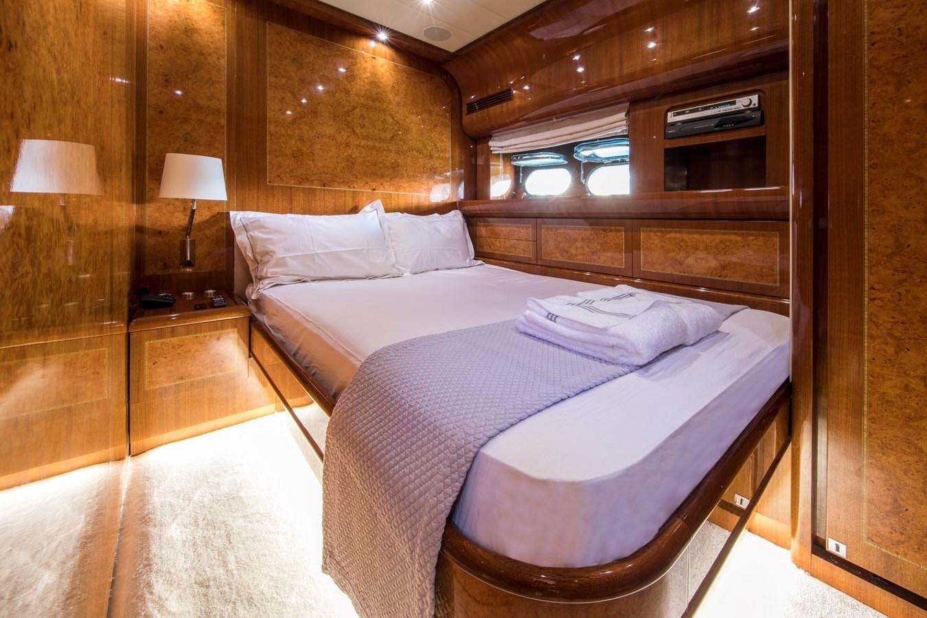 a room with a bed and a lamp aboard CITA Yacht for Sale