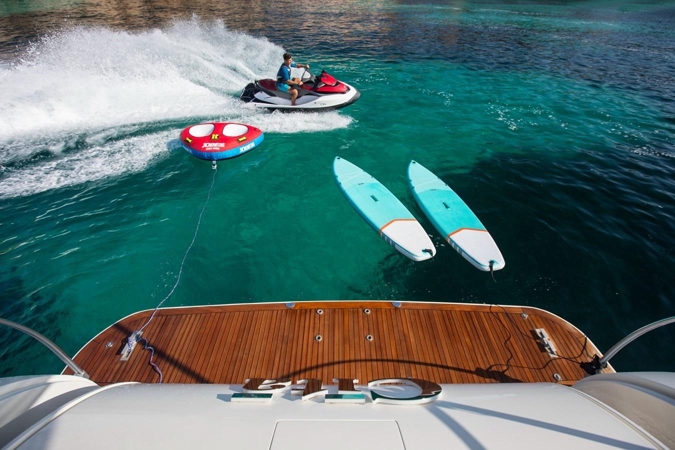 a person on a boat with a surfboard aboard CITA Yacht for Sale
