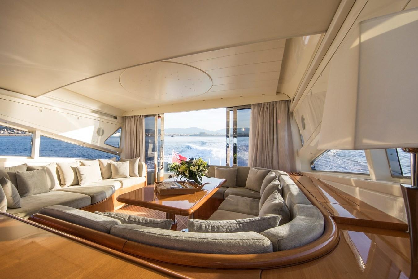 a living room with a couch and a coffee table aboard CITA Yacht for Sale