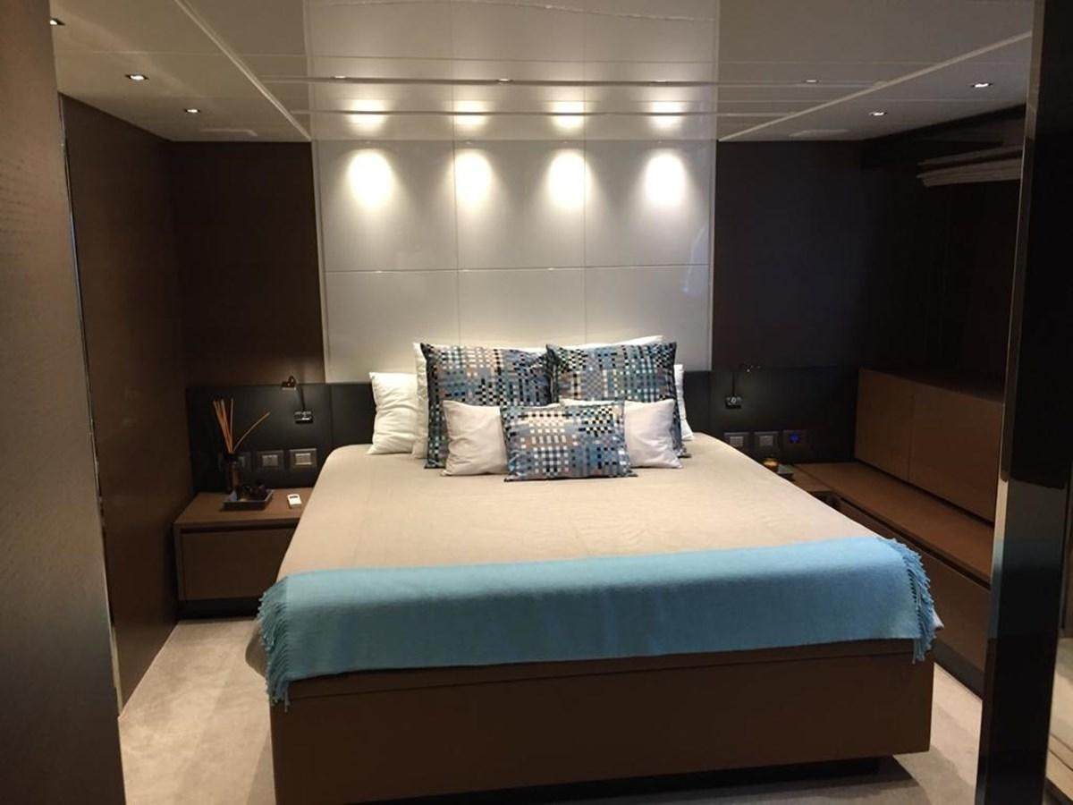 a bed with a blue sheet aboard TAIJI Yacht for Sale