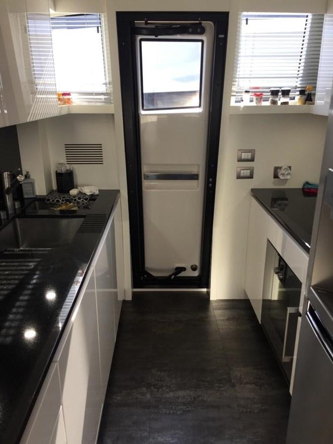 a kitchen with a glass door aboard TAIJI Yacht for Sale