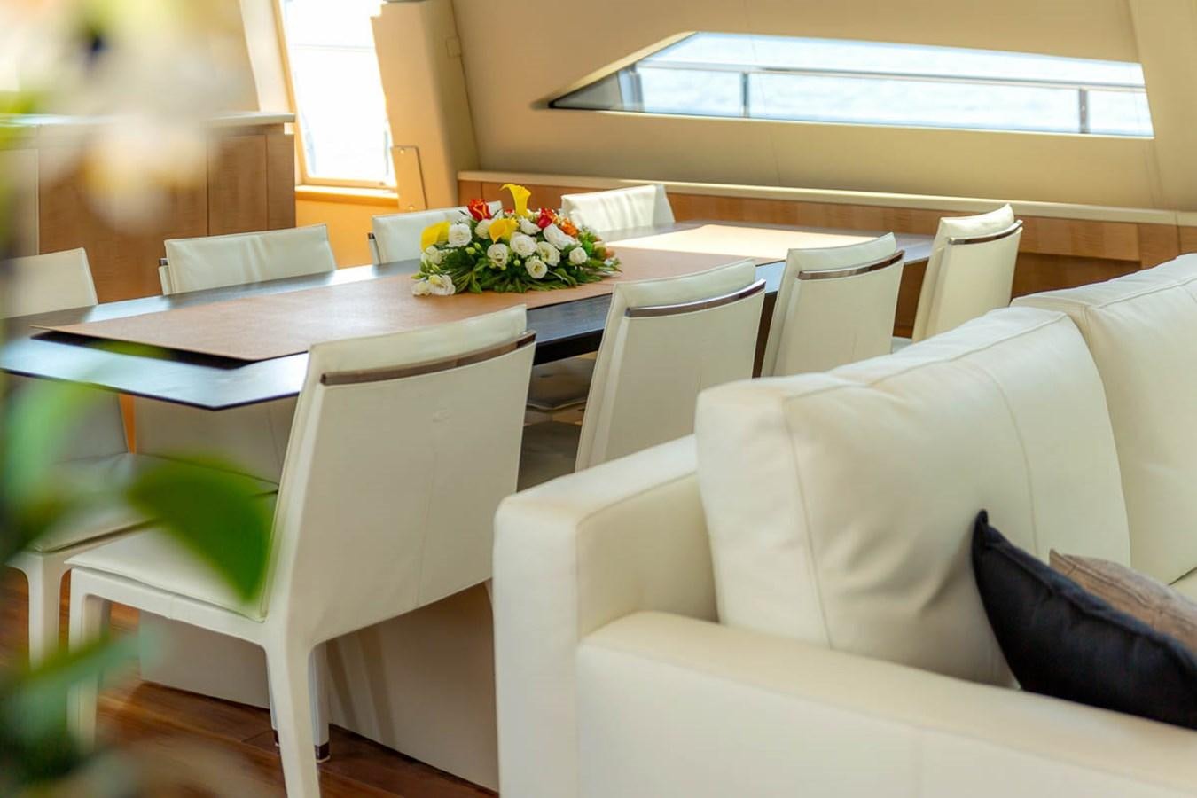 a room with a table and chairs aboard X-TREM II Yacht for Sale