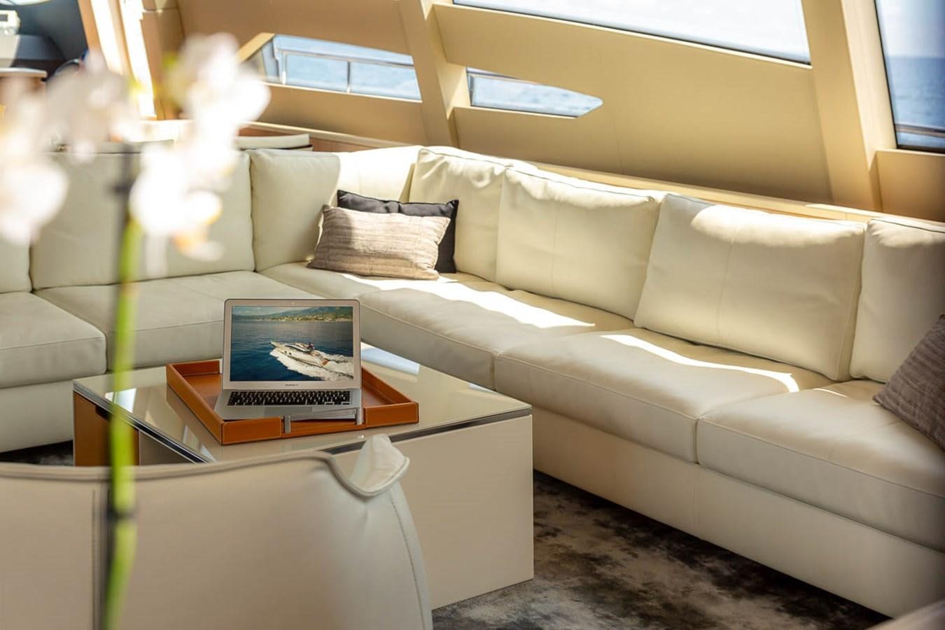 a laptop on a table aboard X-TREM II Yacht for Sale